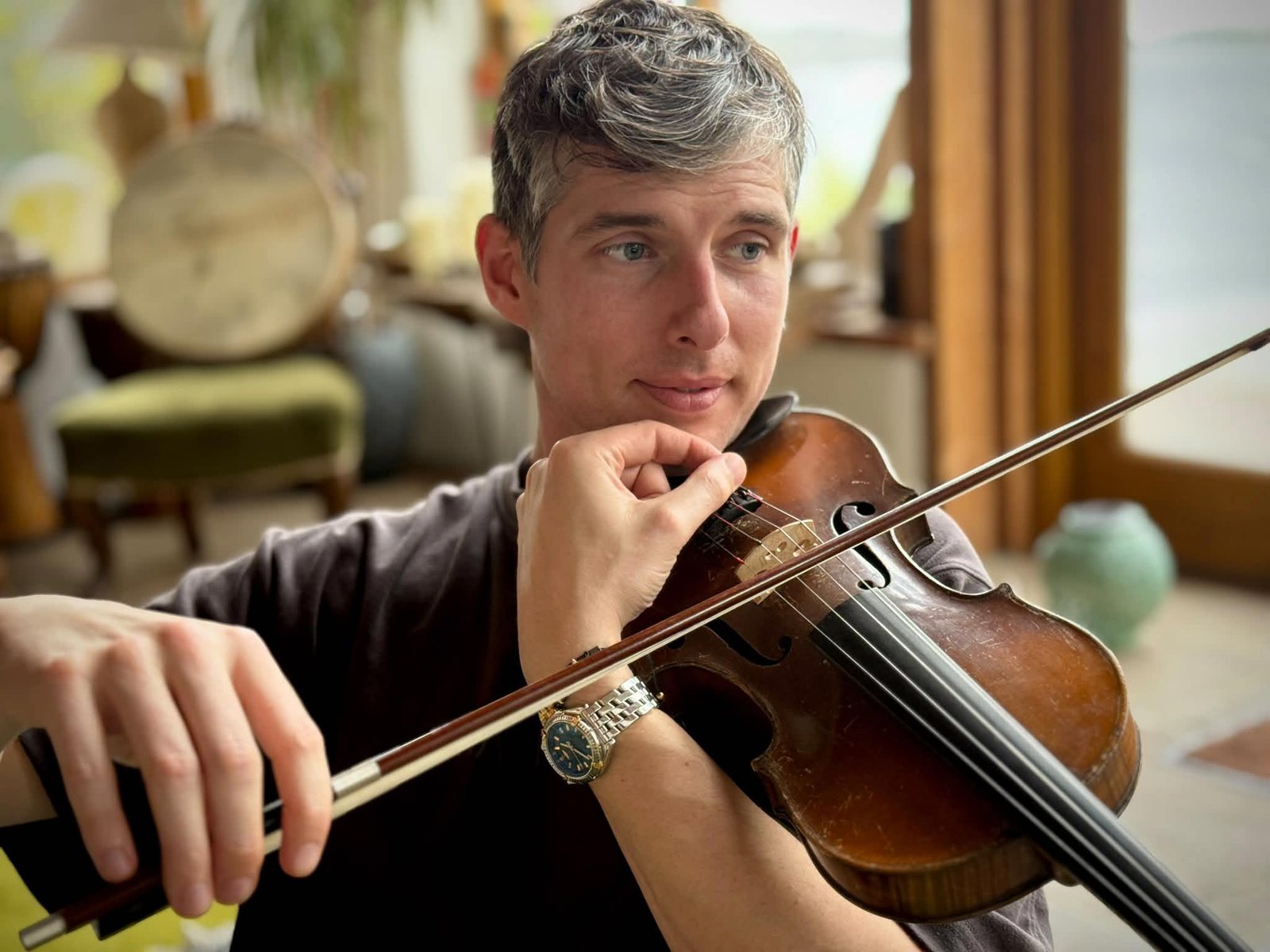 Dave Williams holding the violin and bow